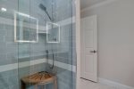 Primary ensuite with stand up shower featuring stool